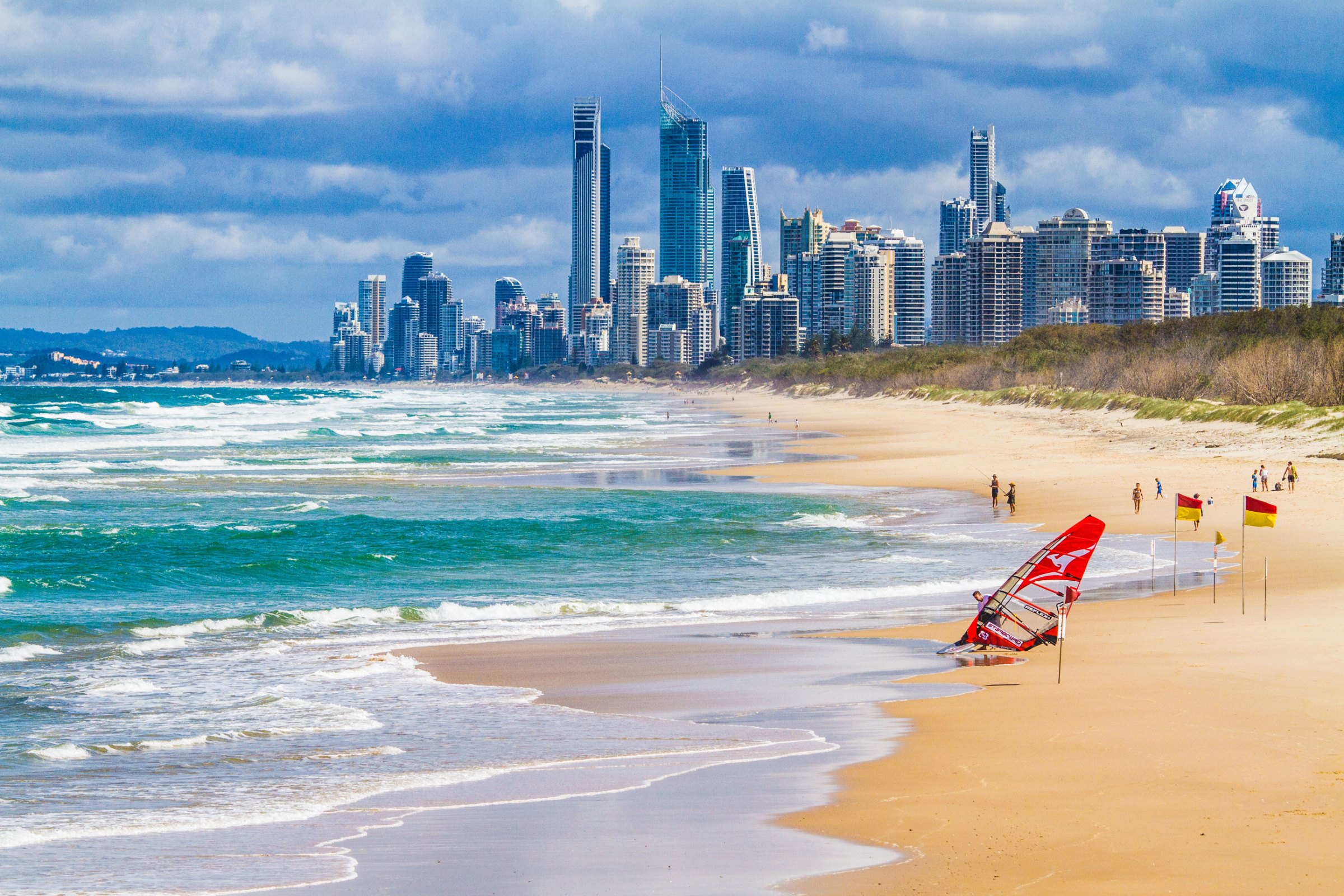 The Gold Coast skyline seen from the sand of a sunny surf beach