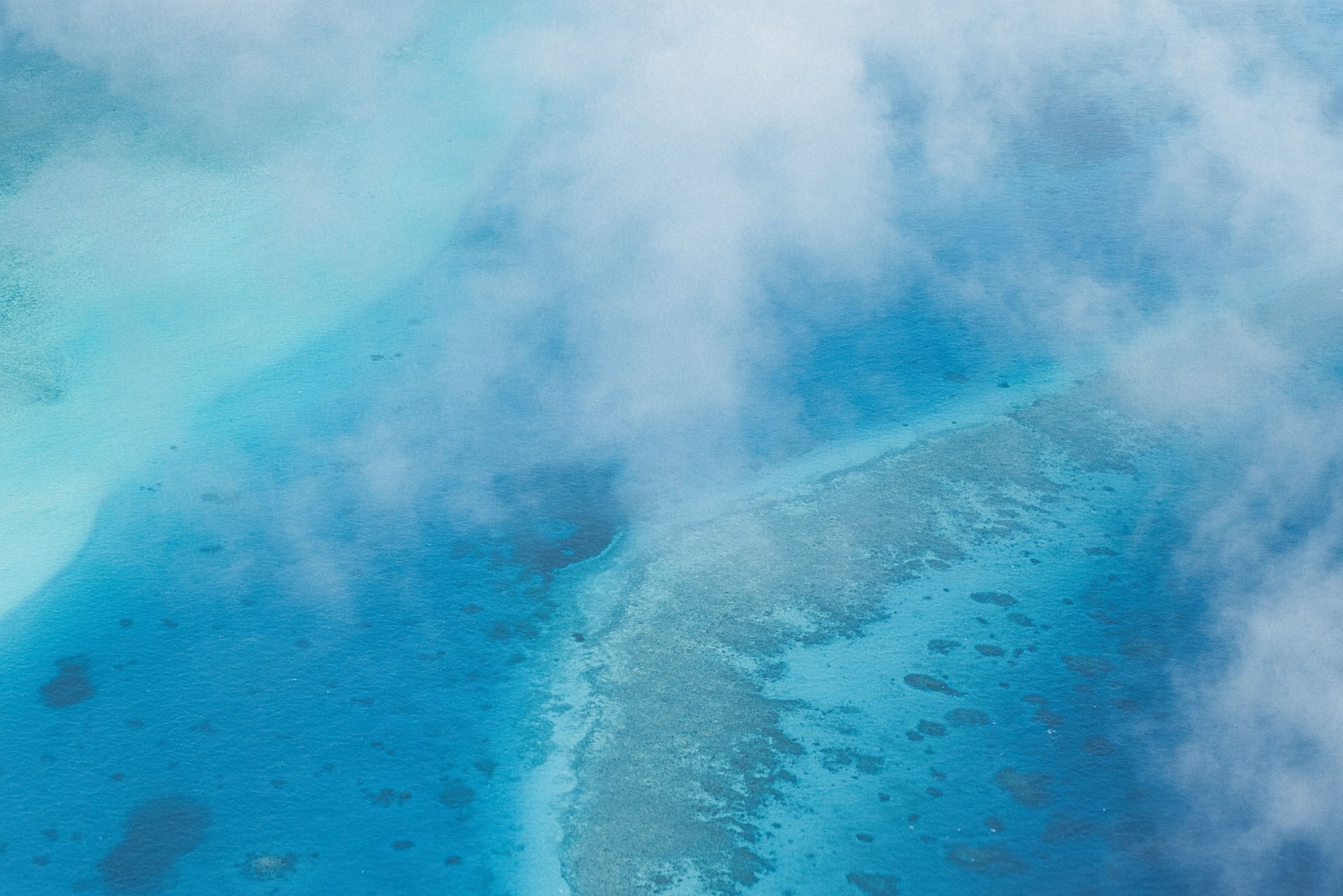 Clear blue water over a shallow reef, seen from the air