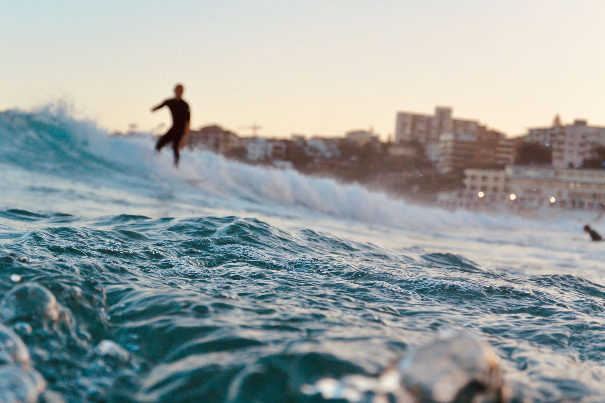 A surfer riding a wave at Bondi Beach